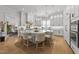 Spacious white kitchen with a large island, hardwood floors, and modern lighting at 1208 Hunting Ridge Rd, Raleigh, NC 27615