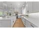 Well-lit kitchen with a central island, stainless steel appliances, and custom cabinetry at 1208 Hunting Ridge Rd, Raleigh, NC 27615