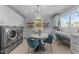 Bright laundry room with modern washer/dryer, cabinets, and a workspace at 1208 Hunting Ridge Rd, Raleigh, NC 27615