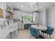 Well-appointed laundry room with a sink, workspace, and ample storage cabinets at 1208 Hunting Ridge Rd, Raleigh, NC 27615
