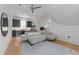 Spacious living room with a kitchenette, comfortable seating, modern lighting, and hardwood floors at 1208 Hunting Ridge Rd, Raleigh, NC 27615