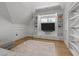 Bright living room featuring a built-in entertainment center, hardwood floors, and a neutral color scheme at 1208 Hunting Ridge Rd, Raleigh, NC 27615