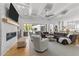 Bright living room boasts a stone fireplace, coffered ceilings, and doors to the outdoor patio at 1208 Hunting Ridge Rd, Raleigh, NC 27615