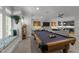 Spacious living room featuring a pool table, window seat, and modern decor at 1208 Hunting Ridge Rd, Raleigh, NC 27615