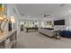 Open-concept living room with a pool table, comfortable seating, and a large television at 1208 Hunting Ridge Rd, Raleigh, NC 27615