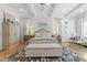Bright main bedroom showcasing hardwood floors, tray ceiling, and stylish furniture at 1208 Hunting Ridge Rd, Raleigh, NC 27615