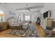Spacious main bedroom featuring hardwood floors, ceiling fan, and elegant furnishings at 1208 Hunting Ridge Rd, Raleigh, NC 27615