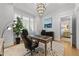 Bright office features a large desk, stylish chair, plantation shutters, and art for a productive and elegant workspace at 1208 Hunting Ridge Rd, Raleigh, NC 27615