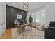 Sophisticated home office with wood-paneled accent wall, a modern light fixture, and ample natural light at 1208 Hunting Ridge Rd, Raleigh, NC 27615
