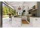 Covered outdoor kitchen with stainless steel grill and bar seating at 1208 Hunting Ridge Rd, Raleigh, NC 27615