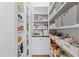 Walk-in pantry with ample shelving and storage space for food and kitchen supplies at 1208 Hunting Ridge Rd, Raleigh, NC 27615
