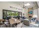 Beautiful covered patio with stone fireplace, tv, fan, and comfortable seating at 1208 Hunting Ridge Rd, Raleigh, NC 27615
