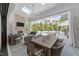 Covered patio with stone fireplace, skylights, fan, outdoor kitchen, and pool view at 1208 Hunting Ridge Rd, Raleigh, NC 27615