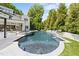 Beautiful backyard with a pool, spa, and manicured landscaping at 1208 Hunting Ridge Rd, Raleigh, NC 27615