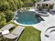 Luxury pool and spa with waterfall features and patio lounge chairs at 1208 Hunting Ridge Rd, Raleigh, NC 27615