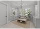 Bright primary bathroom with dual vanities, soaking tub, chandelier, and stylish accents at 1208 Hunting Ridge Rd, Raleigh, NC 27615