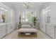 Bright primary bathroom with dual vanities, soaking tub, chandelier, and stylish accents at 1208 Hunting Ridge Rd, Raleigh, NC 27615