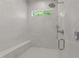 Modern shower with sleek tile, a built-in bench, and a window for natural light at 1208 Hunting Ridge Rd, Raleigh, NC 27615