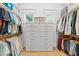 Spacious walk-in closet with custom shelving and drawers for optimal organization and storage at 1208 Hunting Ridge Rd, Raleigh, NC 27615