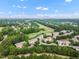 Scenic aerial view of a community featuring a golf course and lush greenery at 12140 Pawleys Mill Cir, Raleigh, NC 27614