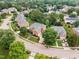 Beautiful aerial view of a tree-lined neighborhood featuring a home with lush landscaping at 12140 Pawleys Mill Cir, Raleigh, NC 27614