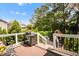 Open-air wood deck with a grill and a view of the manicured backyard with mature trees at 12140 Pawleys Mill Cir, Raleigh, NC 27614