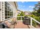Exterior view of a wood deck featuring an outdoor grill and cozy seating arrangement at 12140 Pawleys Mill Cir, Raleigh, NC 27614