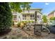 Backyard patio with outdoor seating, a well-maintained lawn, and lush landscaping at 12140 Pawleys Mill Cir, Raleigh, NC 27614