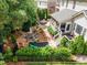 Aerial view of a lush backyard featuring a patio, play set, and ample seating area at 12140 Pawleys Mill Cir, Raleigh, NC 27614