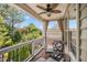 Cozy covered balcony with outdoor seating and a view of the lush backyard and trees at 12140 Pawleys Mill Cir, Raleigh, NC 27614