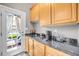 Convenient bar area with sink, coffee maker, and access to the outdoor patio at 12140 Pawleys Mill Cir, Raleigh, NC 27614