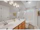 Bright bathroom featuring a double sink vanity with wood cabinets and a shower-tub combo at 12140 Pawleys Mill Cir, Raleigh, NC 27614