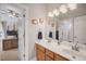 Bathroom featuring double sinks, light fixtures, framed mirrors and a view of the bonus room at 12140 Pawleys Mill Cir, Raleigh, NC 27614