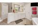 Bathroom vanity with white cabinets, wood-look tile floors, and modern fixtures at 12140 Pawleys Mill Cir, Raleigh, NC 27614