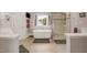 Bright bathroom with a soaking tub, glass shower, and wood-look tile flooring at 12140 Pawleys Mill Cir, Raleigh, NC 27614
