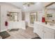 Spacious bathroom featuring dual vanities, large mirrors, and wood-look tile flooring at 12140 Pawleys Mill Cir, Raleigh, NC 27614