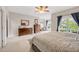 Spacious bedroom featuring large windows, dark wood furniture, and a ceiling fan at 12140 Pawleys Mill Cir, Raleigh, NC 27614