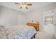 Comfortable bedroom featuring a ceiling fan and a wooden dresser with decorative elements at 12140 Pawleys Mill Cir, Raleigh, NC 27614