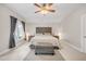 Comfortable bedroom featuring neutral decor, a tufted headboard, and a ceiling fan at 12140 Pawleys Mill Cir, Raleigh, NC 27614