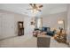 Inviting bonus room features a blue couch, chess set, ceiling fan and an arcade game at 12140 Pawleys Mill Cir, Raleigh, NC 27614