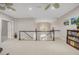 Neutral bonus room with white railing and black banister, view of the stairwell and chandelier at 12140 Pawleys Mill Cir, Raleigh, NC 27614