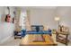 Cozy bonus room with a blue couch, chess set, guitars on the wall and lots of natural light at 12140 Pawleys Mill Cir, Raleigh, NC 27614