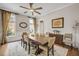 Bright dining room featuring a wooden table, neutral-toned chairs, and natural light from the large window at 12140 Pawleys Mill Cir, Raleigh, NC 27614