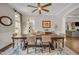 Dining room featuring a large hardwood table, modern ceiling fan and neutral paint at 12140 Pawleys Mill Cir, Raleigh, NC 27614
