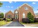 Front view of brick home featuring a landscaped front yard and inviting entranceway at 12140 Pawleys Mill Cir, Raleigh, NC 27614
