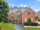 Charming two-story brick home with manicured lawn and inviting front entrance at 12140 Pawleys Mill Cir, Raleigh, NC 27614