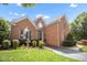 A brick house with manicured greenery and stone walkway leading to the front entrance at 12140 Pawleys Mill Cir, Raleigh, NC 27614