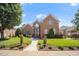 Beautiful brick two-story home featuring a landscaped front yard and inviting entranceway at 12140 Pawleys Mill Cir, Raleigh, NC 27614