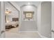 Hallway leading to a bedroom, showcasing neutral colors and a decorative niche with artwork at 12140 Pawleys Mill Cir, Raleigh, NC 27614