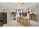 Bright home office with dual monitors, guitars displayed on the wall, and a ceiling fan at 12140 Pawleys Mill Cir, Raleigh, NC 27614